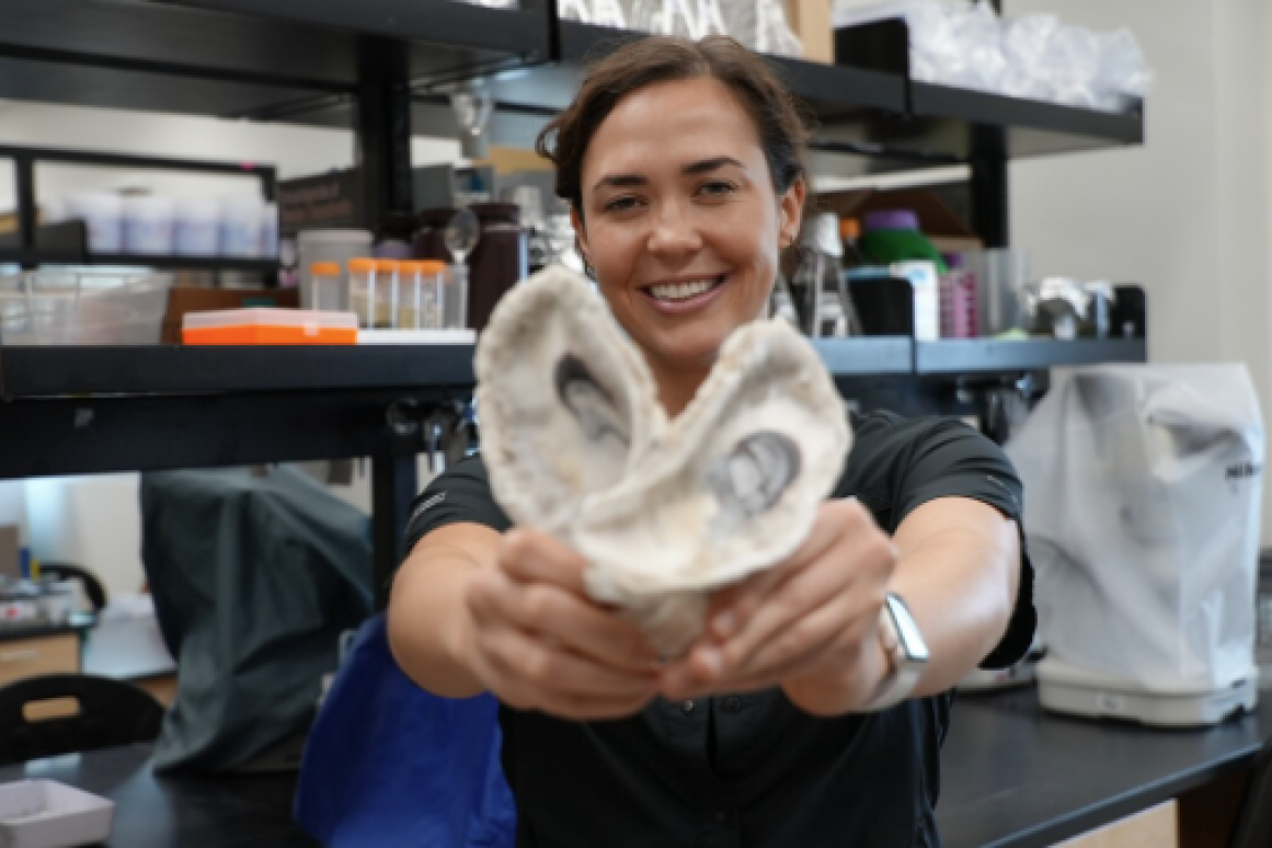 Kelley Savage holds oyster shells for carbon dating